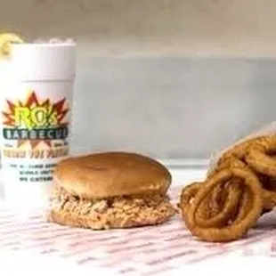 An awesome large BBQ sandwich with their secret recipe, deep fried onion rings and their specialty an ice cold &quot;Cherry Lemon Sundrop&quot; soda!