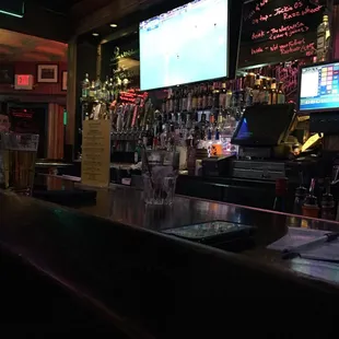  a bar with a large screen tv