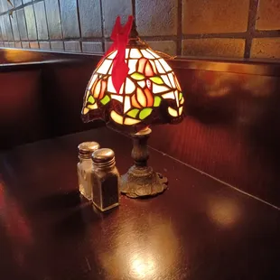 a table with a lamp and salt shaker