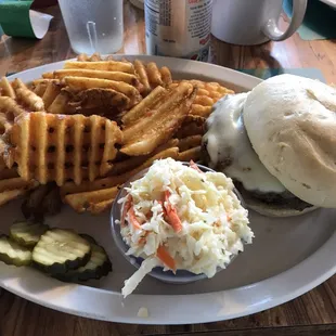 a hamburger, fries, coleslaw and pickles