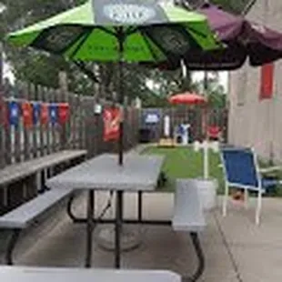 a picnic table with an umbrella