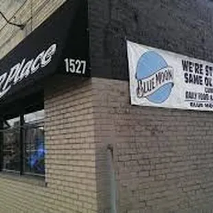 a brick building with a black awning