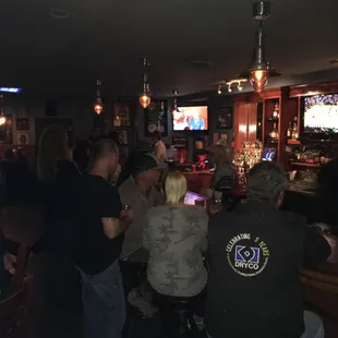 a group of people sitting at a bar