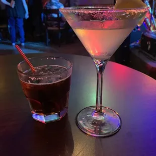 a martini and a drink on a table