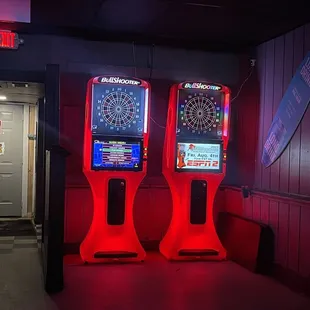 two arcade machines with red lights