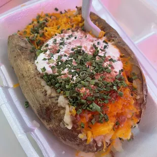 Loaded spud, cheese, butter, sour cream and chives.