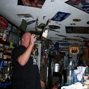 a man drinking a bottle of liquor