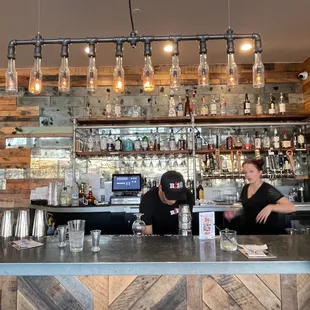 two people sitting at a bar