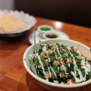 a bowl of salad with a fork in it