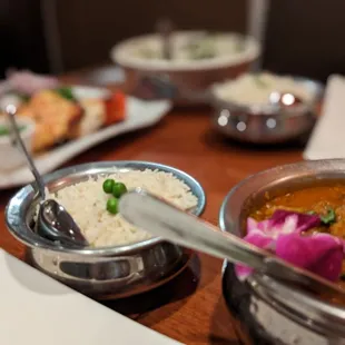 a variety of dishes on a wooden table