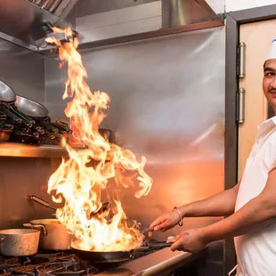 Chef Raman preparing Tadka Dal with a sizzling blend of spices.