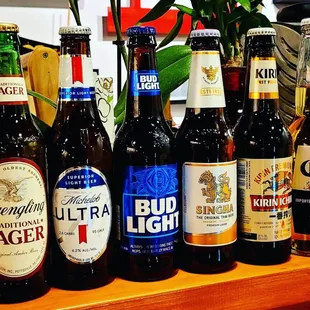 a variety of beer bottles on a counter