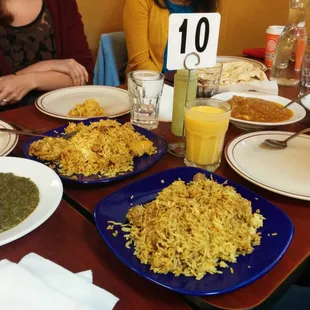 Some of the dishes from our family style meal: biriyanis (chicken and lamb), saag paneer, mango lassi, and fish karahi