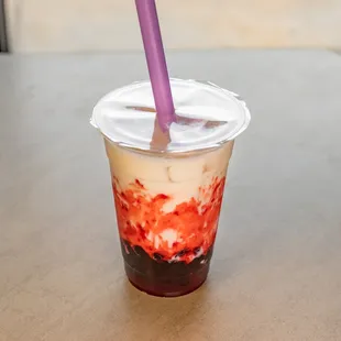 a plastic cup with a purple straw