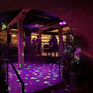 Dance floor with bar back right.