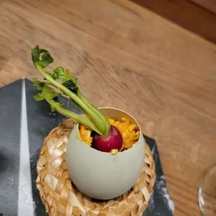 Scramble egg with tiny vegetable in straw hat