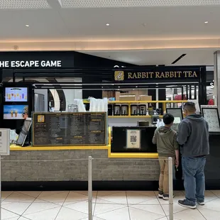 two people standing in front of a counter