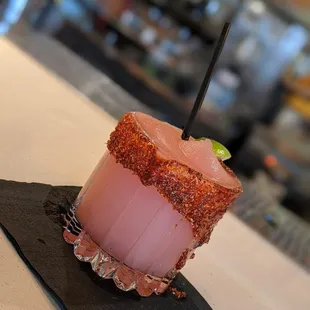 a pink drink with a straw
