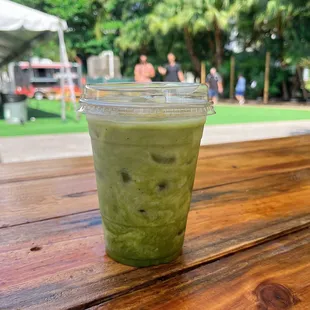 a green drink on a wooden table