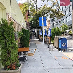 tables and chairs on the sidewalk