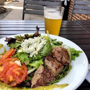 a plate of food and a glass of beer