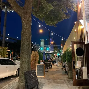 people sitting on benches under a tree