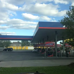 a gas station with cars parked in front of it