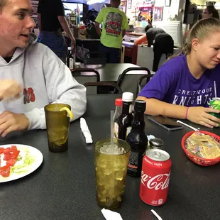 a couple of people eating at a table