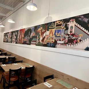 a long dining room with tables and chairs