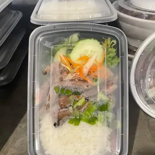 a plastic container filled with rice and meat