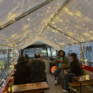 inside of a boat with people sitting at tables