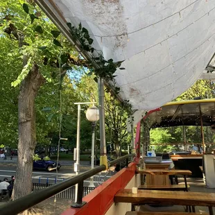 a patio with tables and umbrellas