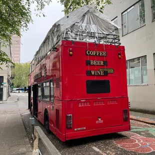 a red double decker bus parked on the side of the road