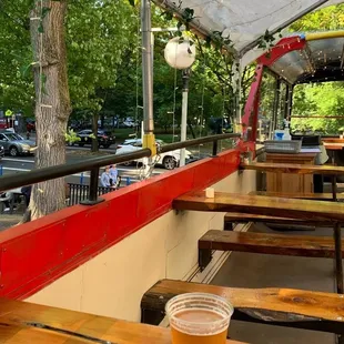 a view of a patio with tables and benches