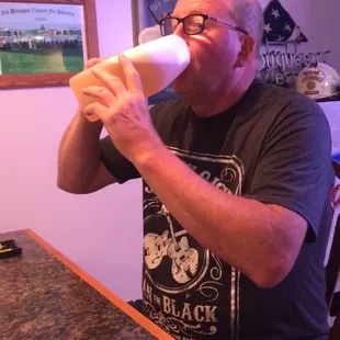 a man drinking from a mug