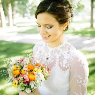 Photo by Madison Wathen. Bridal bouquet of Ranunculus, Anemone, Larkspur, Viking Pompons, Misty Blue Limonium. www.DesignsByRachelKY.com