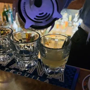 a person pouring a drink