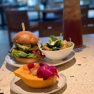 Double Cheeseburger with bacon and Avocado with a Caesar side salad and a side of fruit!
