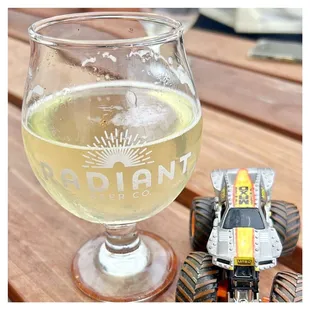 a glass of beer and a toy car