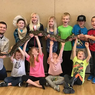 The whole gang helping to hold Brucinda the TEN FOOT Burmese python!