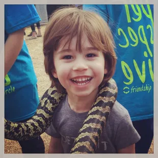 My 3 year old son holding a huge snake (with supervision / support form Mike).