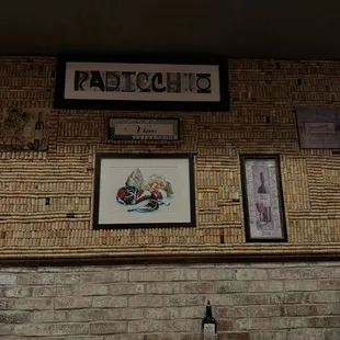 a table and chairs in front of a brick wall
