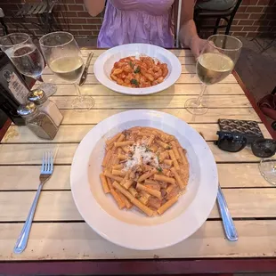 a plate of pasta and a glass of wine