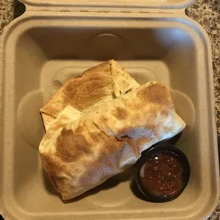 a burrito in a styrofoam container