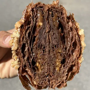 a hand holding a chocolate pastry