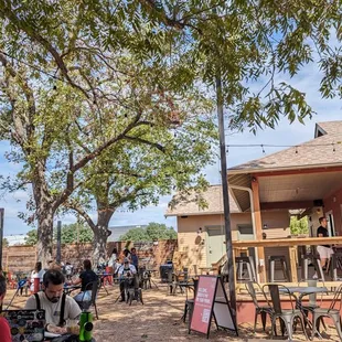 a group of people sitting outside a restaurant