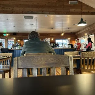 people sitting at tables in a restaurant