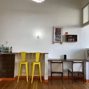 a bar with two yellow chairs