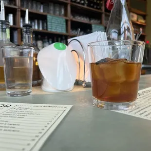 a glass of iced tea on a bar