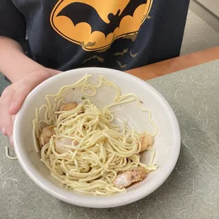 Partially eaten kids noodles with shrimp